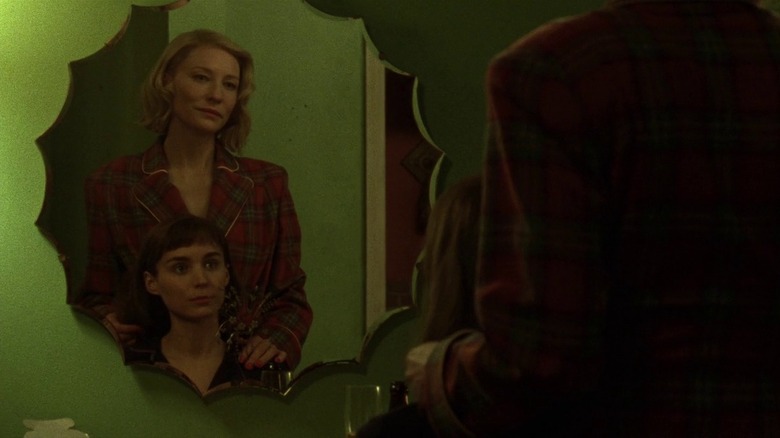 Therese and Carol looking in mirror