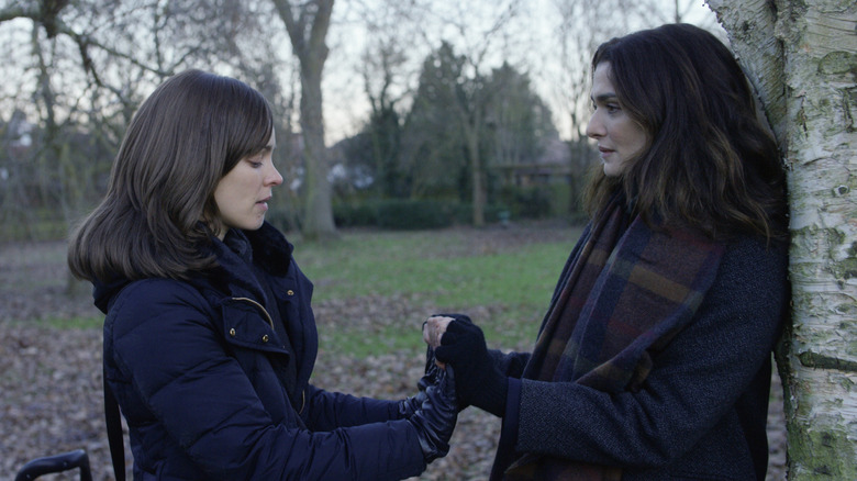 Ronit and Esti holding hands outside by trees