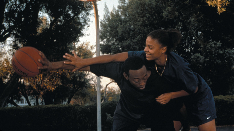 Monica and Quincy playing basketball outside