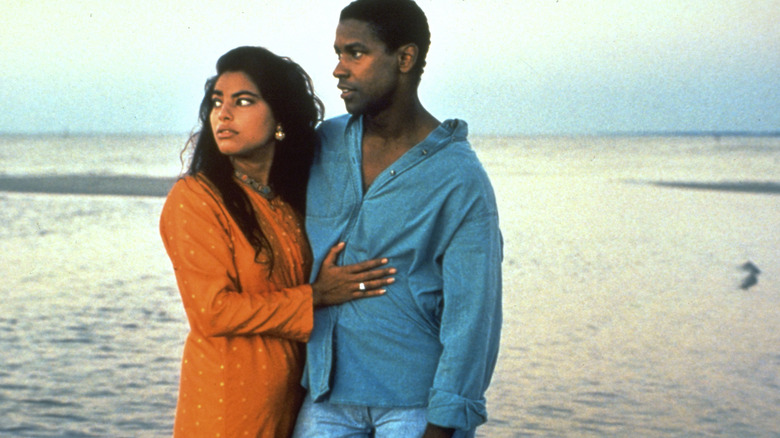 Mina and Demetrius standing on beach looking out