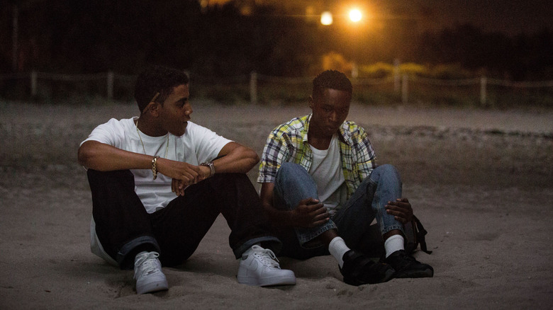 Chiron and Kevin sitting on the beach at night