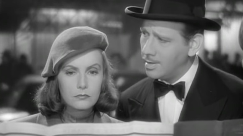 Ninotchka and Count Léon looking at street map