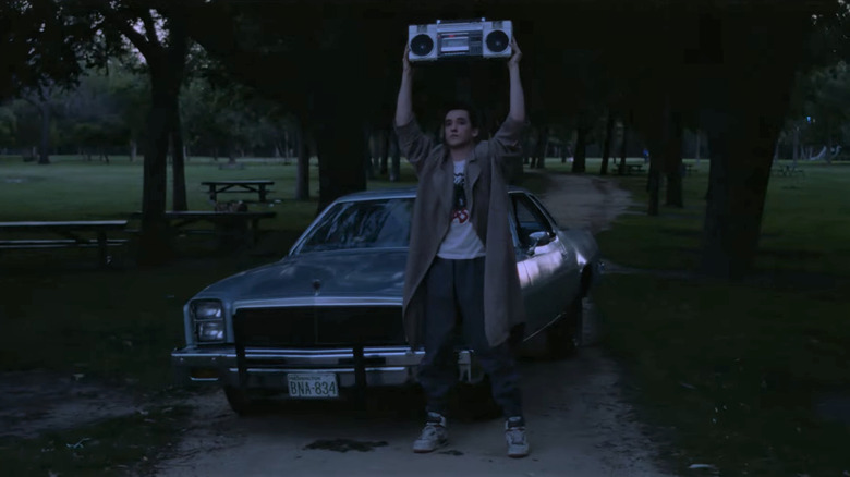 Lloyd outside holding boombox over his head