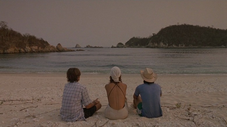 Tenoch, Luisa, and Julio sitting on the beach