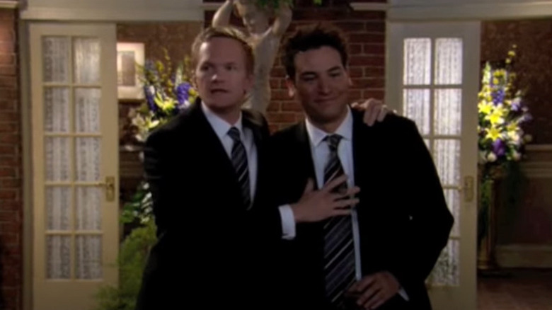 Barney Stinson clutches Ted Mosby