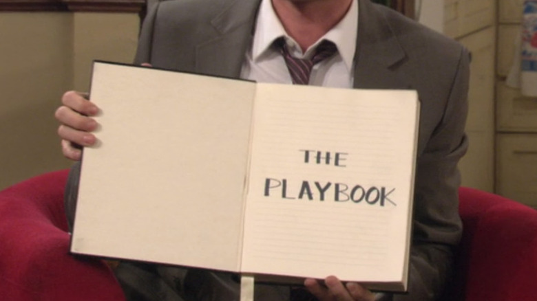 Barney Stinson holding Playbook