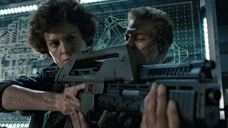 Ripley holding rifle