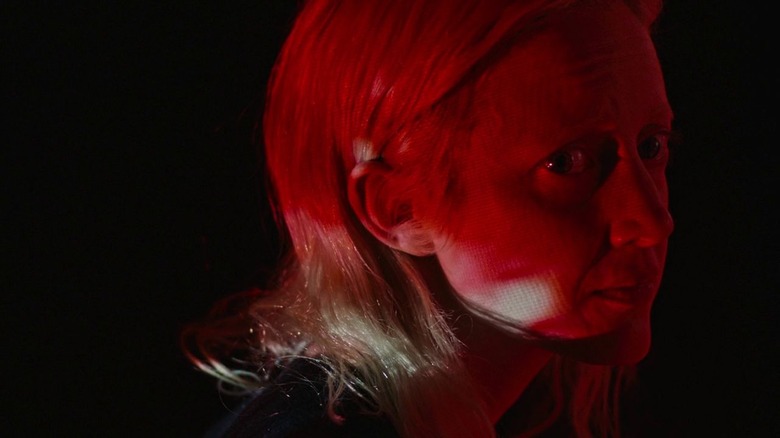 Andrea Riseborough in red lighting