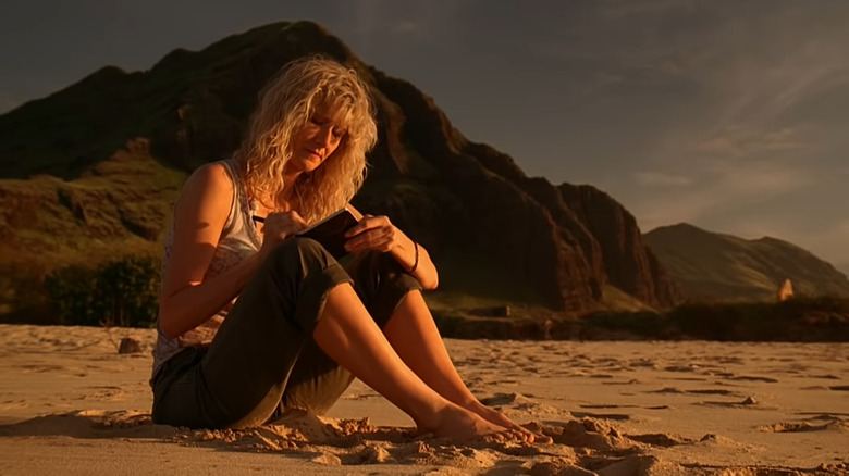 Amy Jellicoe writing on beach