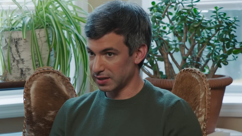 Nathan Fielder sitting near plants