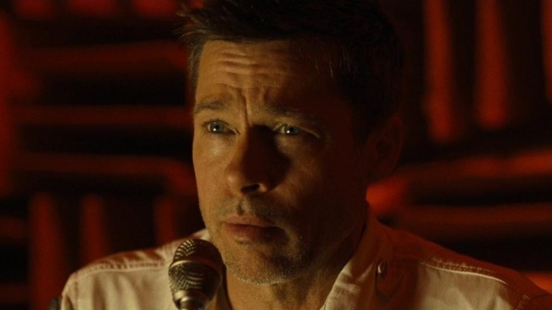 Brad Pitt speaking into microphone in Ad Astra