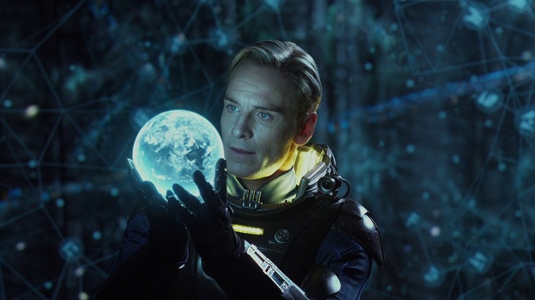 Michael Fassbender holding globe