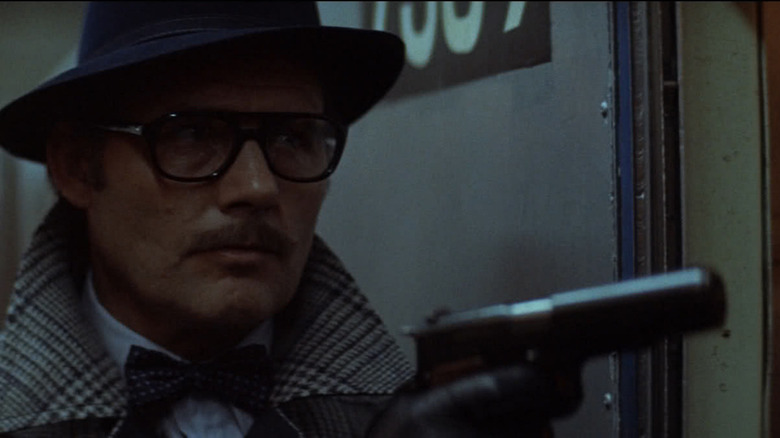 Robert Shaw holding gun