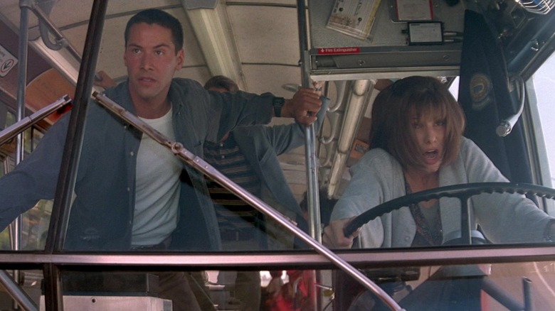 Keanu Reeves and Sandra Bullock riding the bus