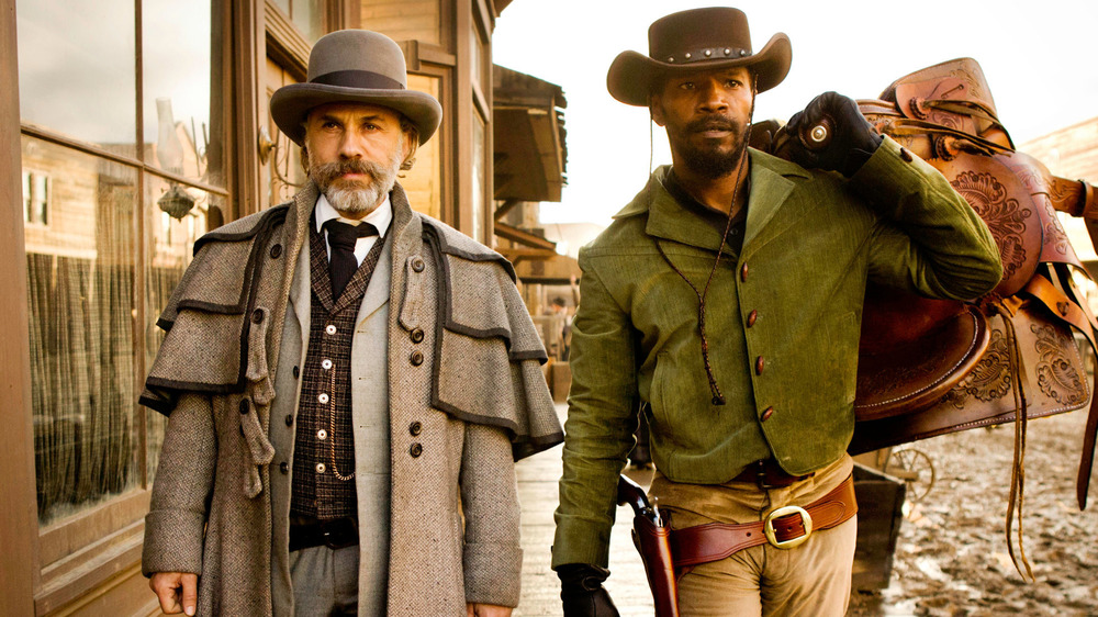 Django and Schultz walking in Western town