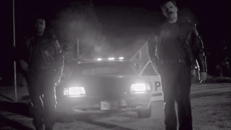 Police officers in front of police car