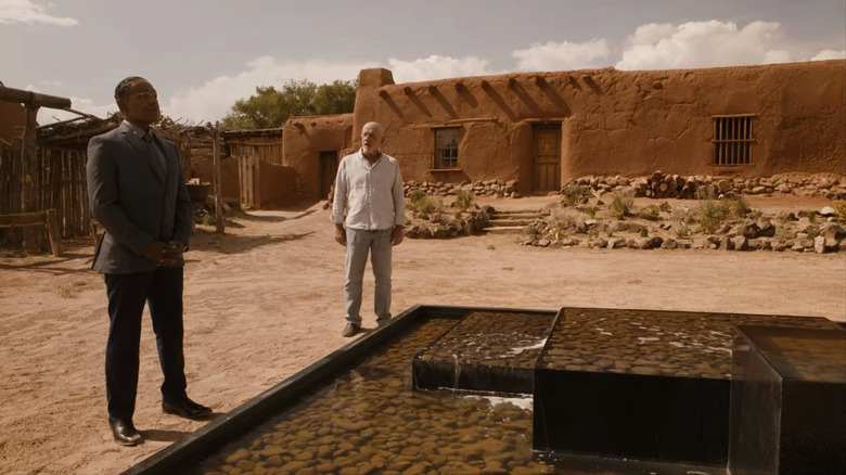 Gus and Mike talking by a fountain