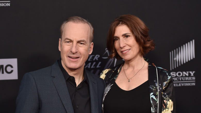 Bob and Naomi Odenkirk smiling for cameras.