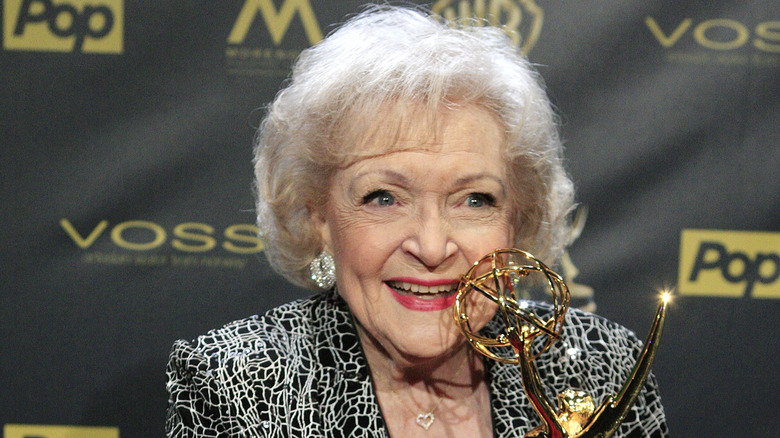 Betty White smiling with award