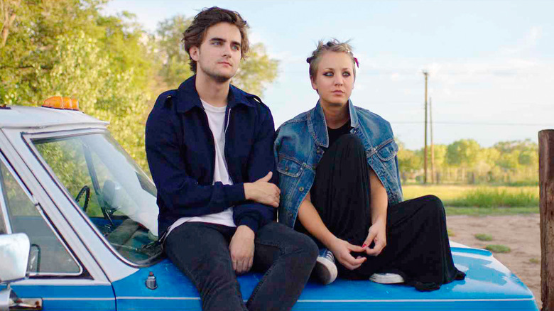 Dylan and Katy sitting on a car