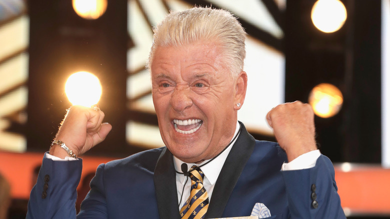 Derek Acorah raises fists, bares teeth