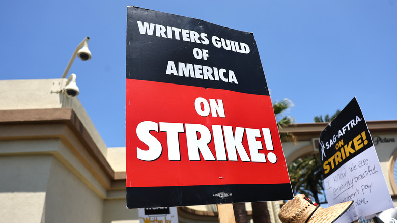 People holding up strike signs