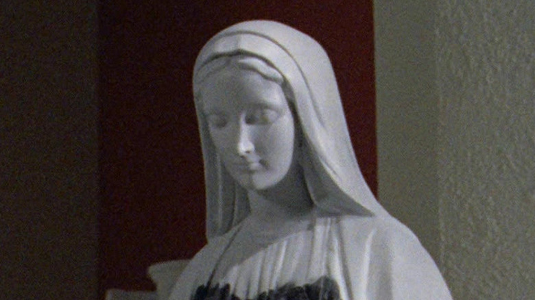 The Mary statue stands desecrated