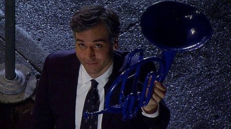 Ted holds up the horn