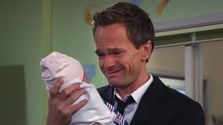 Barney holds his baby