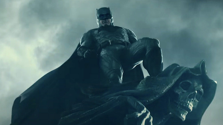 Batman standing on gargoyle