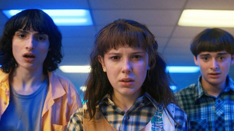 Mike, Eleven, and Will looking shocked