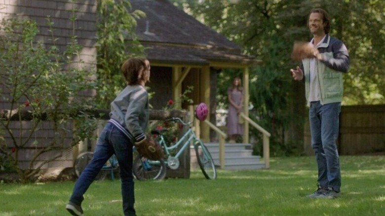 Sam playing ball with Dean Jr. wife on porch