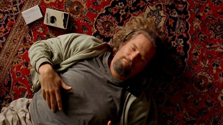 The Dude listens to tape deck on the floor