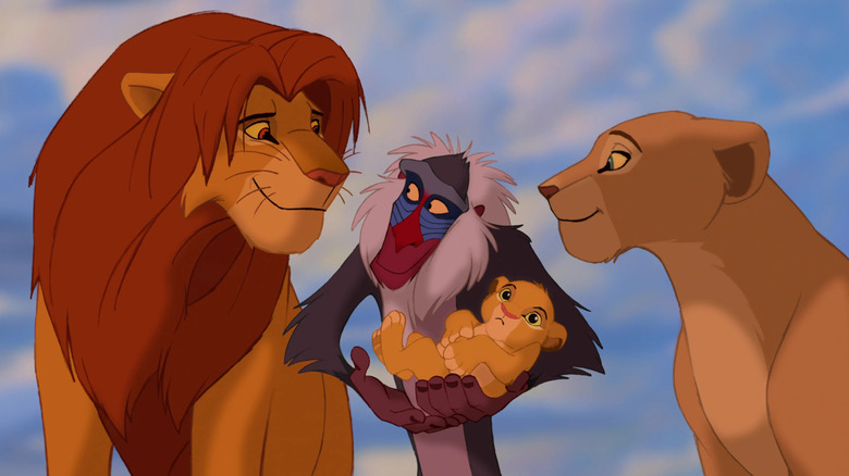 Rafiki holding Simba and Nala's baby