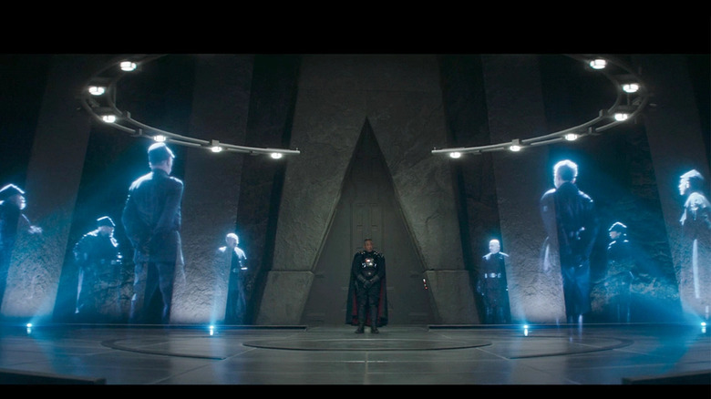 Moff Gideon standing with holograms