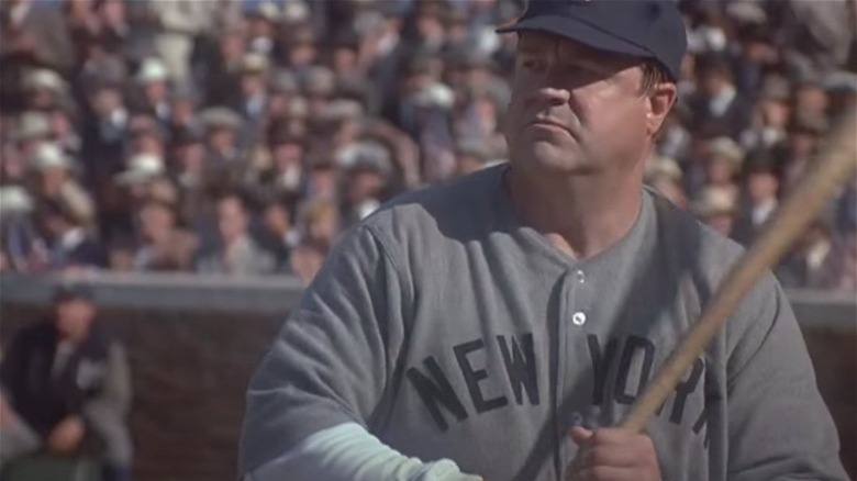 John Goodman as Babe Ruth, holding baseball bat