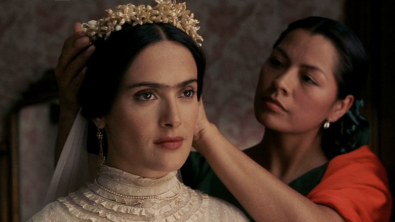 Woman puts headpiece on Salma Hayek