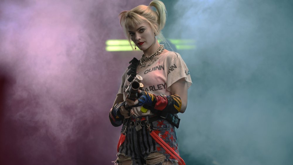 Harley Quinn holding gun in smoke