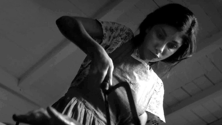 Kika Magalhaes wields a saw 