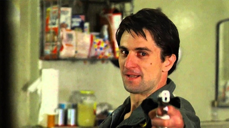 Travis Bickle aiming a gun at a mirror