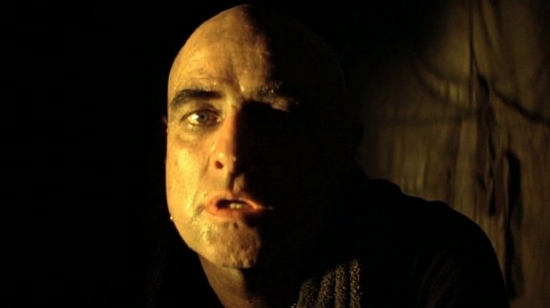 Bald Brando with half his face in shadow 