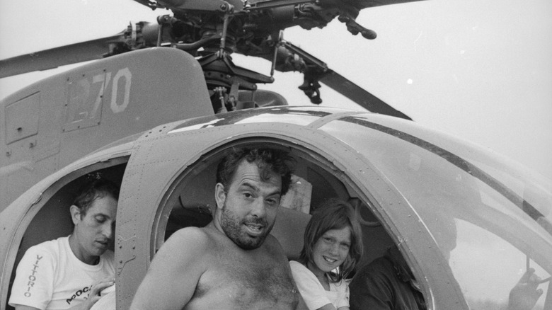 Coppola sitting in a helicopter 