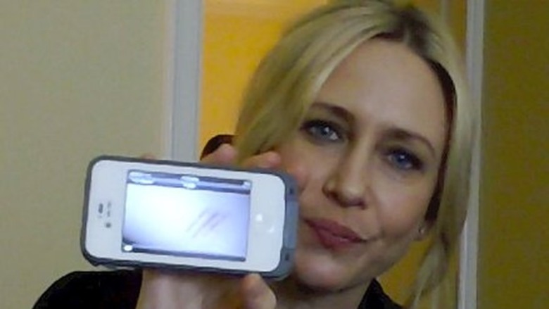 Vera Farmiga shows cell phone