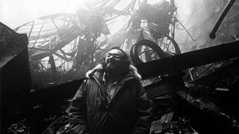 Kubrick laughing in front of burned down set