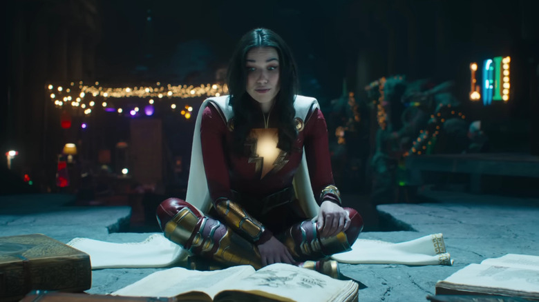 Mary Marvel sitting in front of books