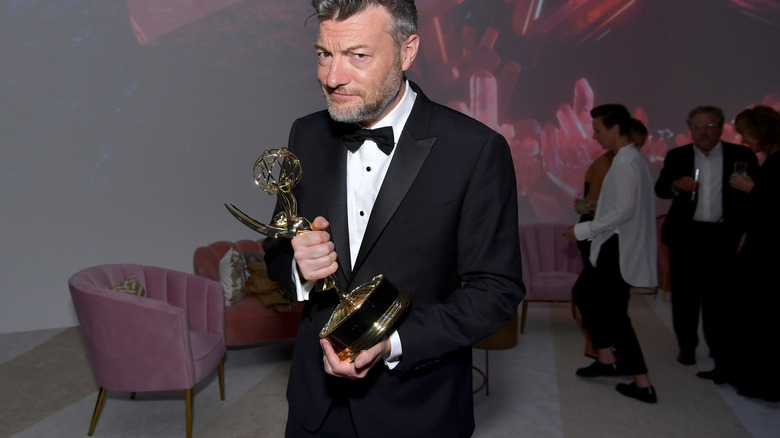 Charlie Brooker with an award