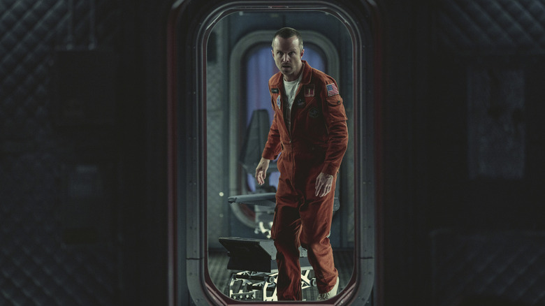 Aaron Paul in spaceship in flight suit