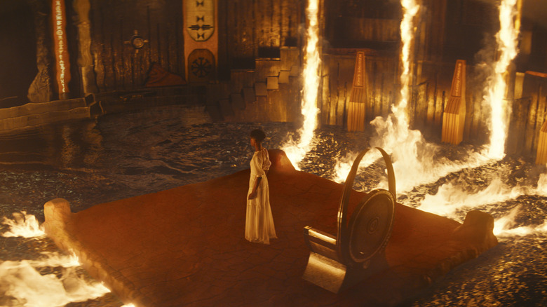 Shuri on a throne room base amidst burning water