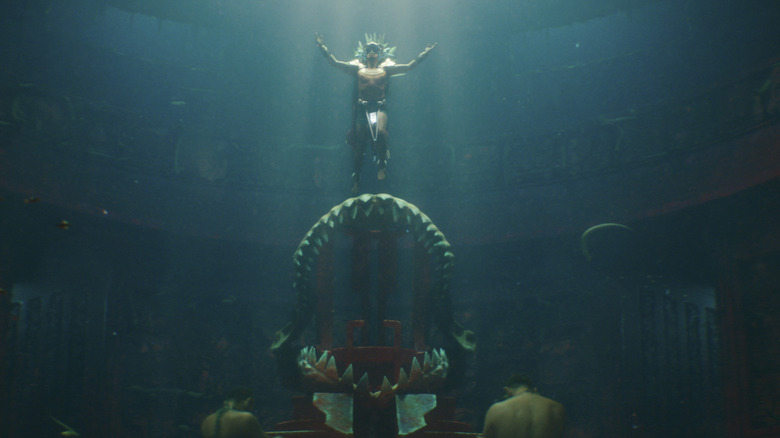 Namor descending onto a shark-teeth throne