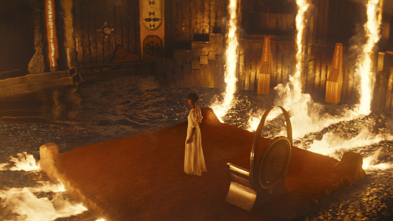 Shuri on a burning platform beside the throne